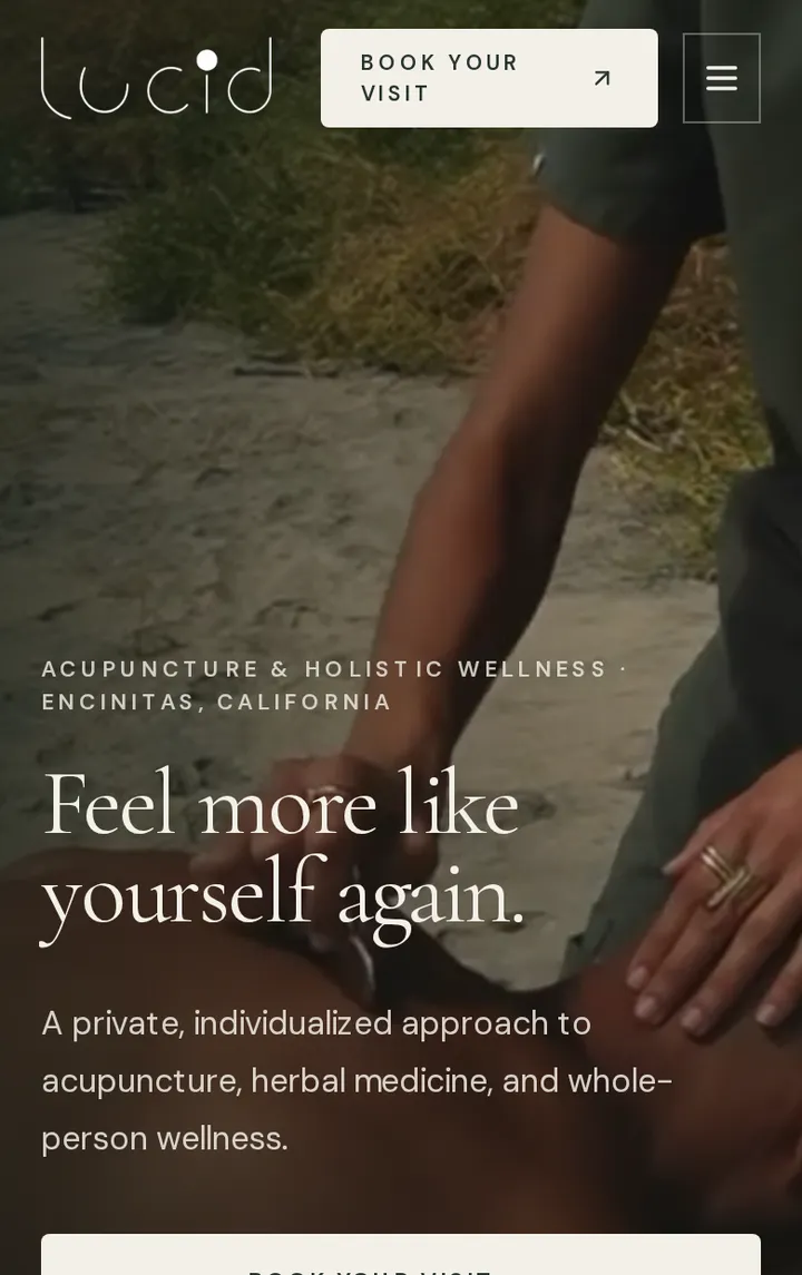 The Lucid Acupuncture homepage on a phone: a treatment photograph behind the heading Feel more like yourself again, with a Book your visit button.